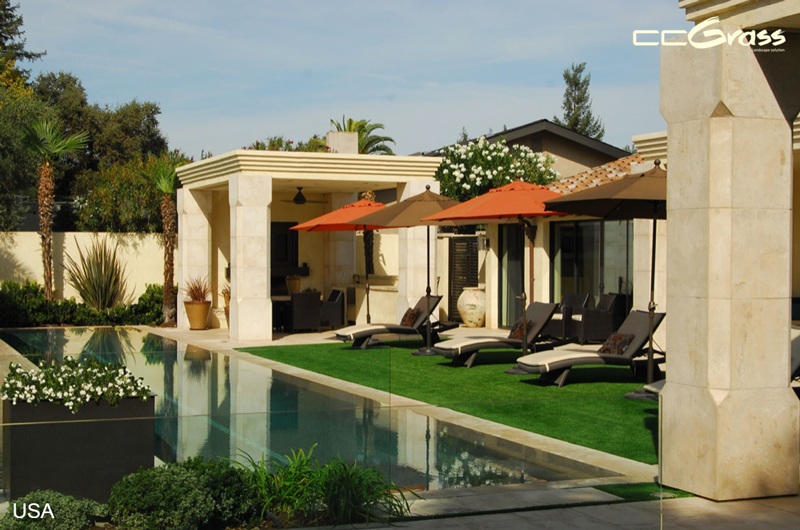 artificial grass around backyard pool with lounge area
