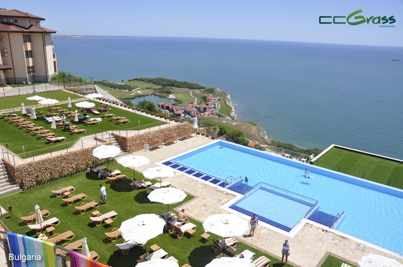resort-style poolside with clean and green artificial turf
